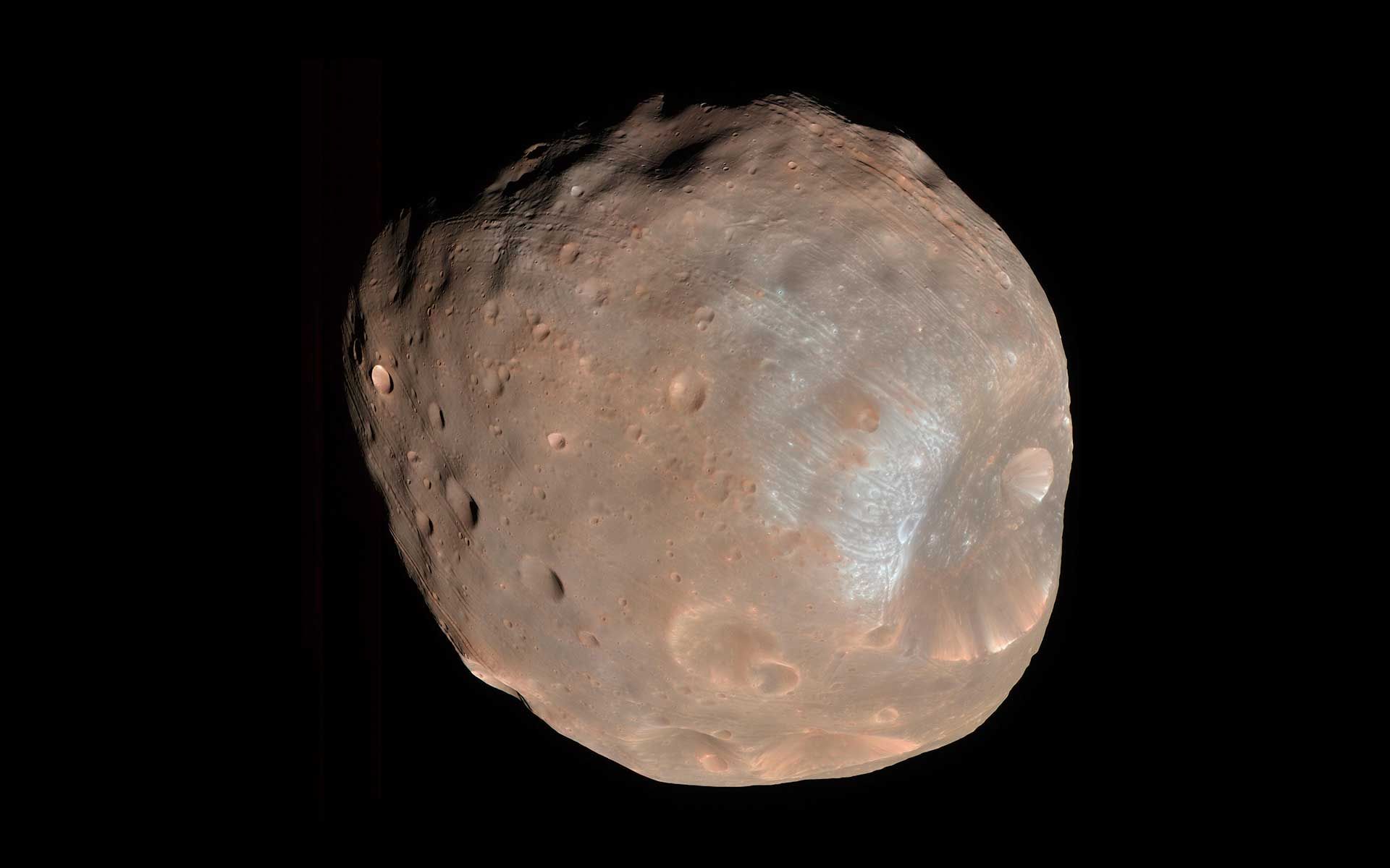 Mars' moon Phobos is seen against the darkness of space.