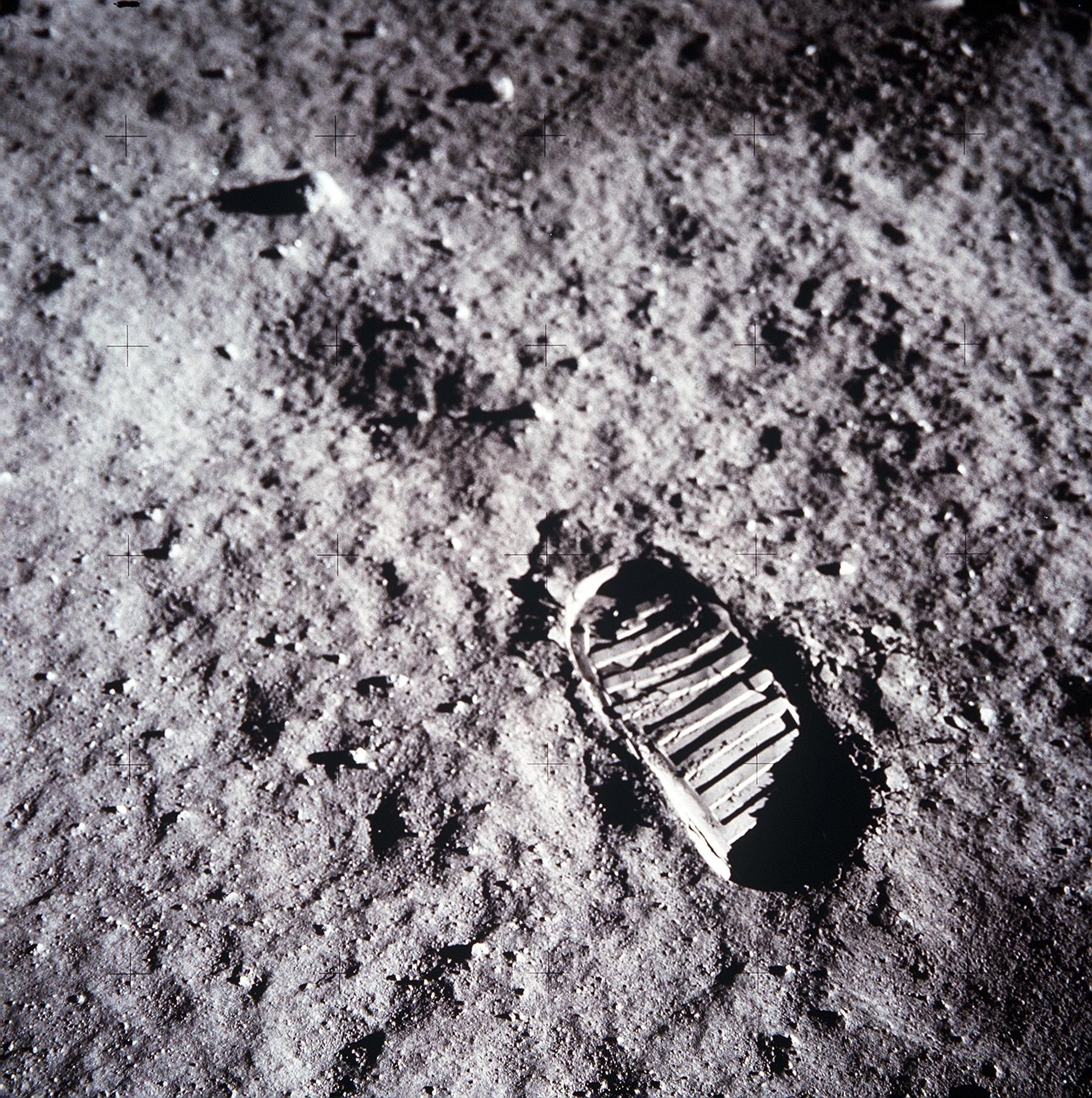 Black and white photo of a boot print left on the moon's surface