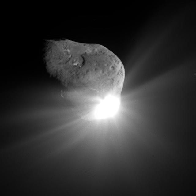 Image of potato-shaped comet soon after NASA's Deep Impactor spacecraft hit the comet. Bright light is glowing from one end of the comet.
