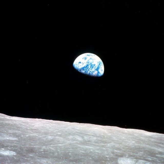 earth over barren lunar horizon
