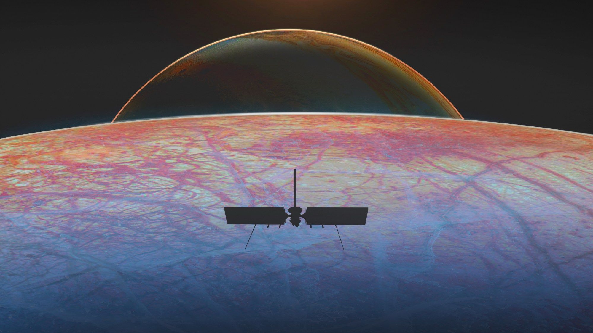 An illustration shows a spacecraft in silhouette above an icy moon's surface with reddish fractures. Beyond the moon's horizon, the planet Jupiter sits in the distance.