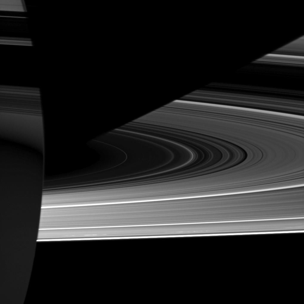 Capturing the interplay between light and shadow, the Cassini spacecraft looks toward the night side of Saturn where sunlight reflected off the rings has dimly illuminated what would otherwise be the dark side of the planet.