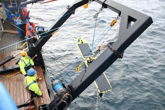 A Wave Glider is recovered for maintenance.