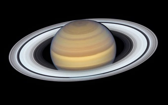 The rings around Saturn glow brightly white.