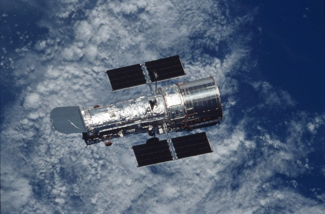 The Hubble spacecraft in orbit with the earth under it.