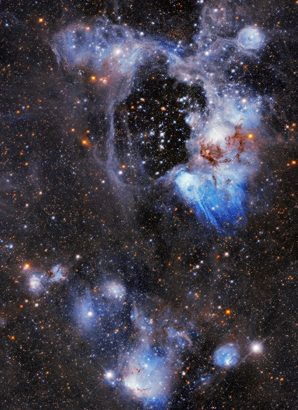 Upper 2/3 holds a bright white and blue gas and dust-cloud ring around a central void or bubble. lower 1/3 holds blue and white