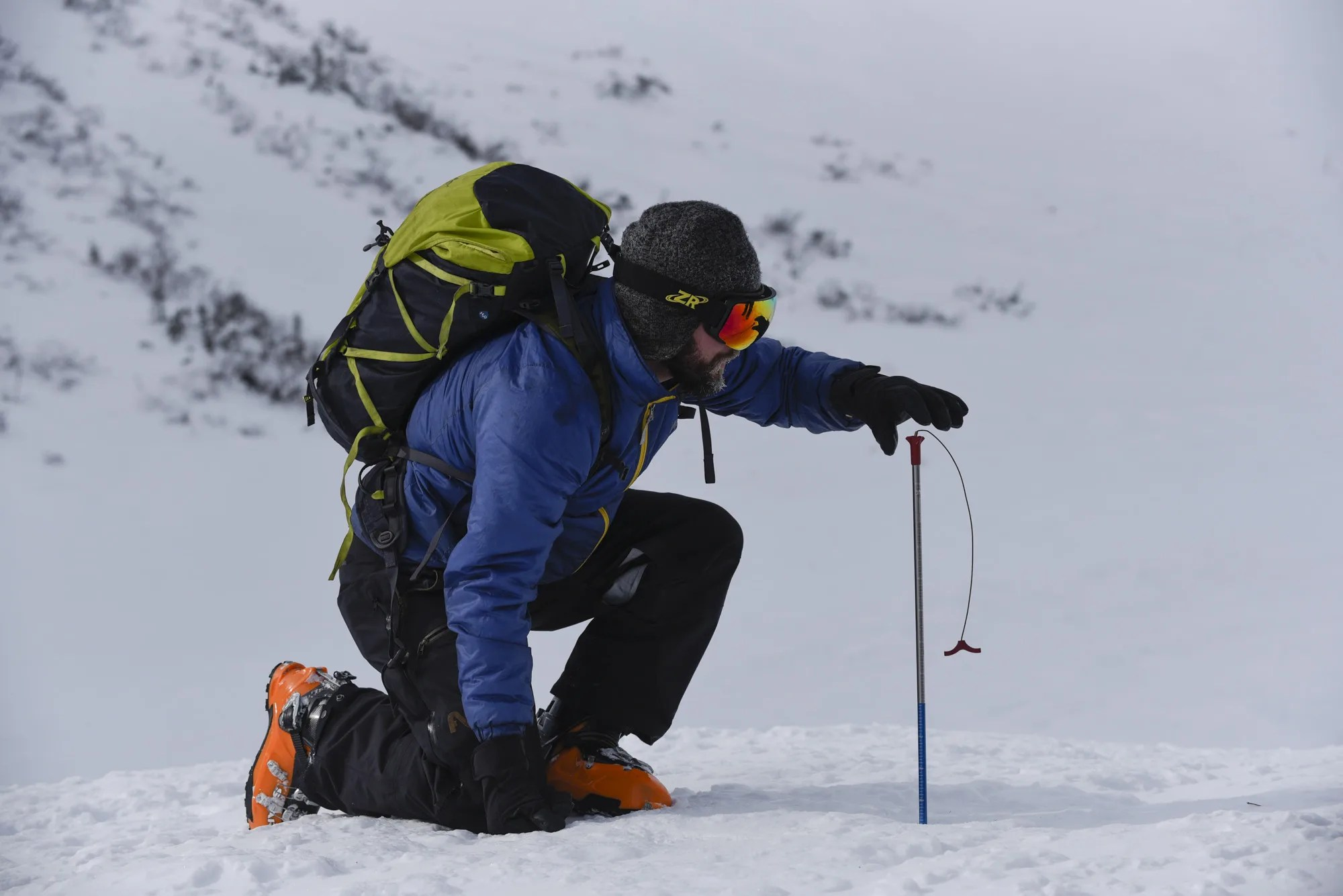 Ryan Crumley measures snow depth in the White Mountains of New Hampshire.