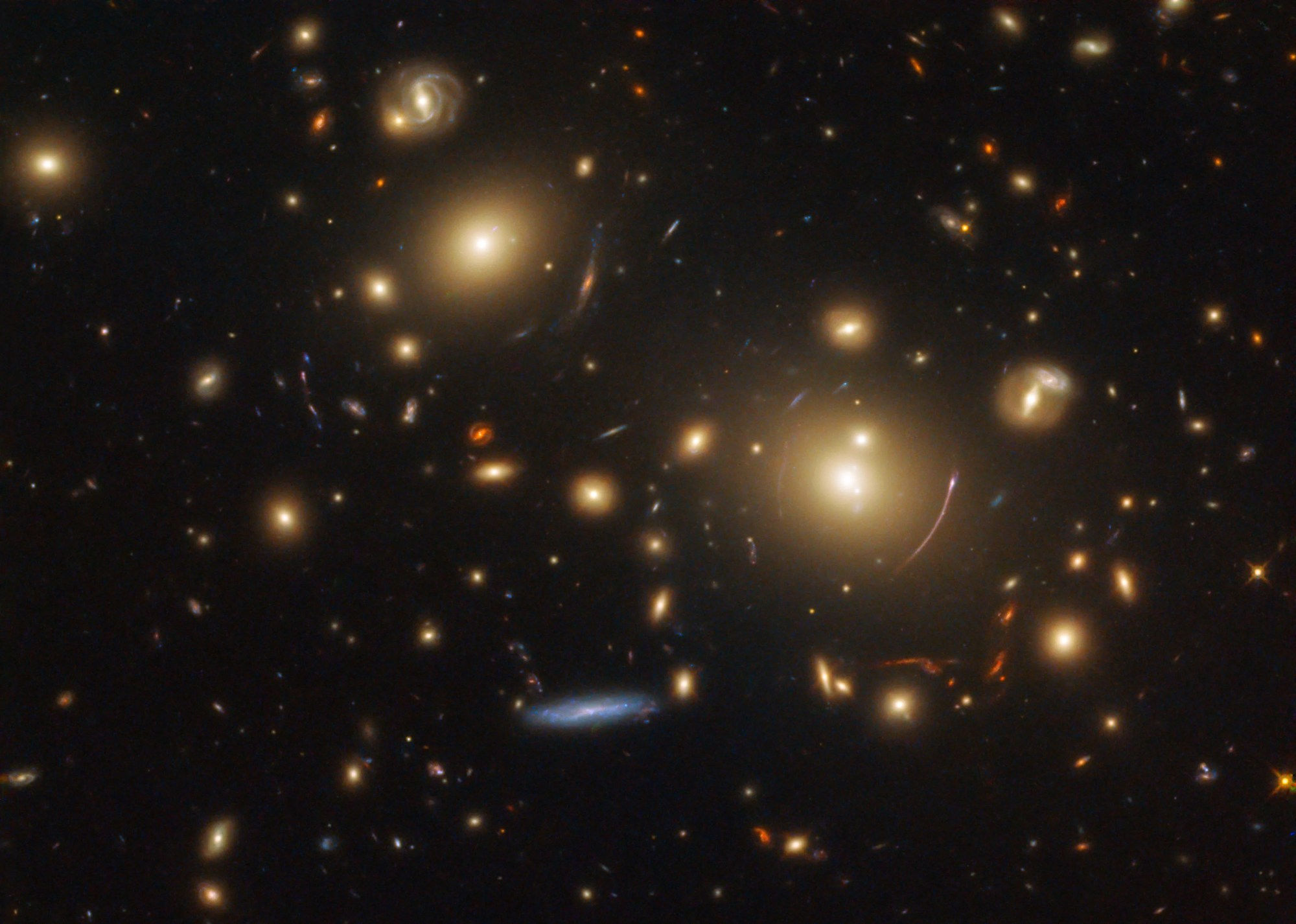 Cluster of amber and blue galaxies, some distorted