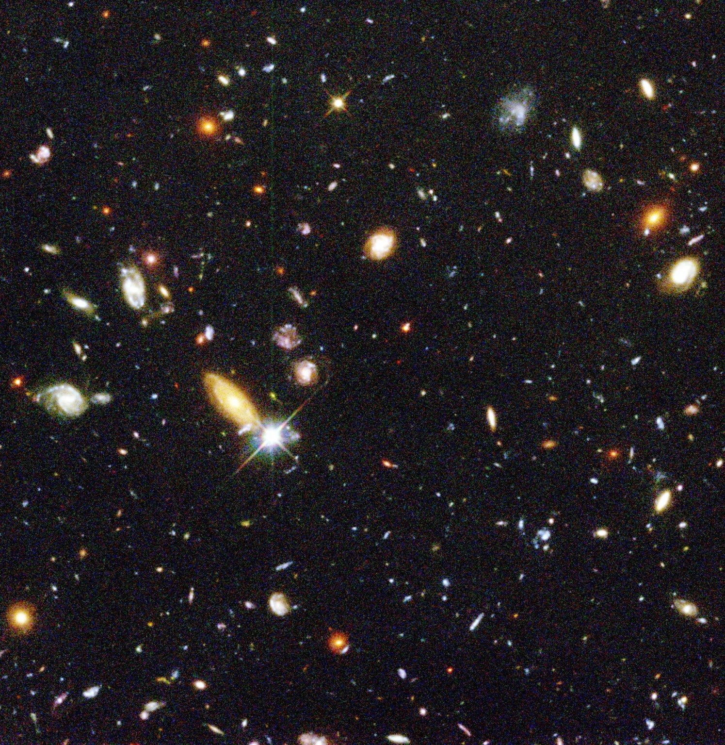 Field is filled with galaxies in colors of white, yellow, blue-white, and red; all on a black background.