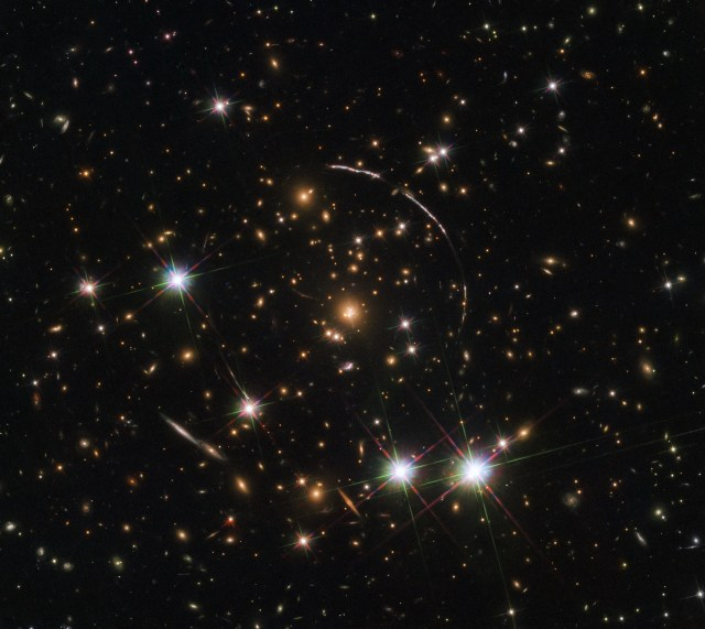 Hubble image of remote galaxy exhibiting gravitational lensing