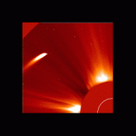 The Sun's atmosphere, shown in red, with a bright white stream of a comet shooting through it.
