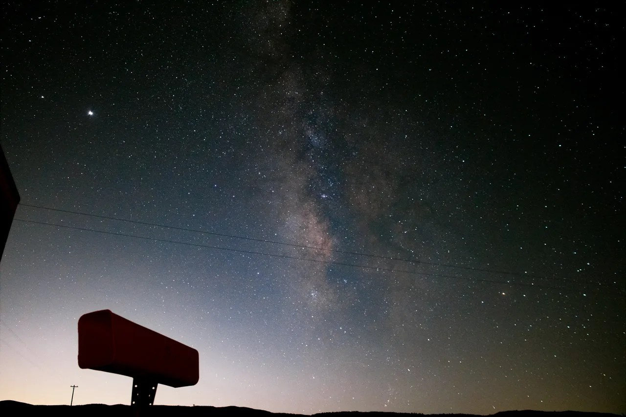 Photo of the Milky Way with skyglow on the horizon