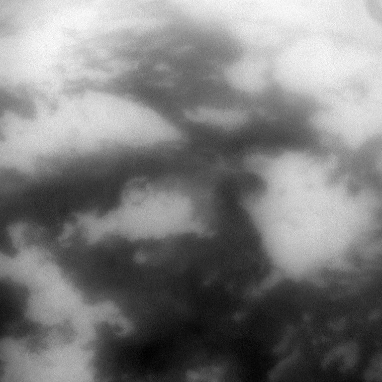 The low albedo feature known as Senkyo is visible through the haze of Titan's atmosphere. The image was taken with the Cassini spacecraft narrow-angle camera on Oct. 12, 2009 using a spectral filter sensitive to wavelengths of near-infrared light centered at 938 nanometers. The view was acquired at a distance of approximately 296,000 kilometers (184,000 miles) from Titan