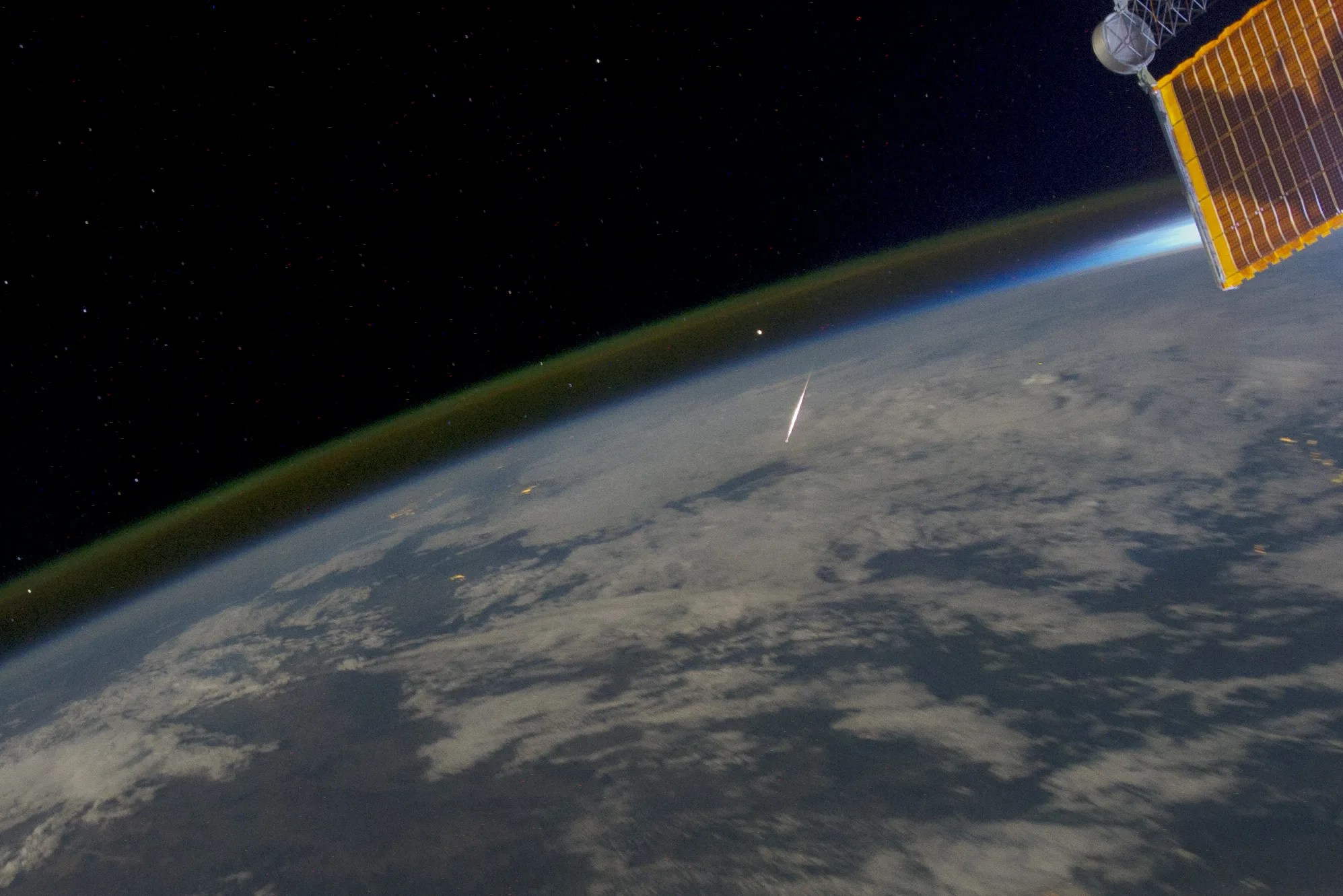 bright streak above curved earth seen from above