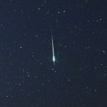 Closeup view of a bright meteor flaring against a dark background sky