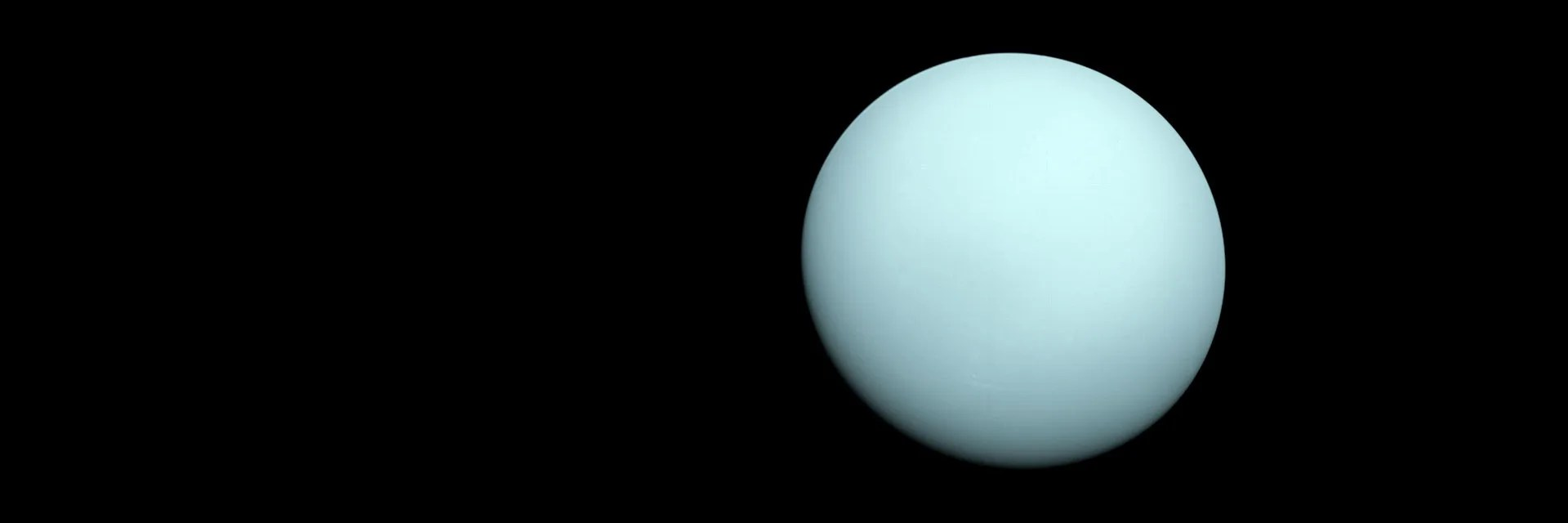 A full disk view of Uranus against the darkness of space.