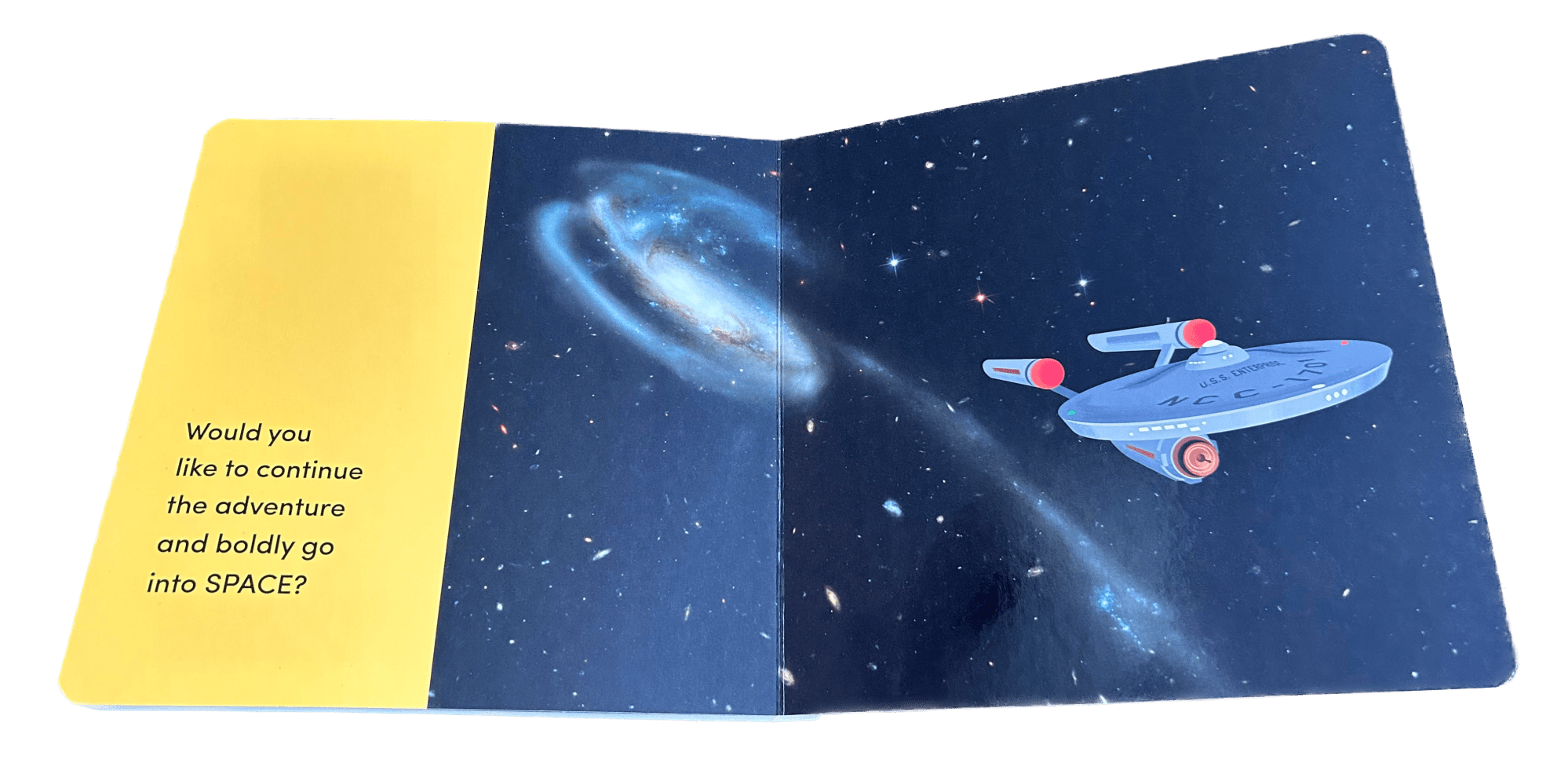 A child's board book shows Hubble's image of the Tadpole Galaxy with a cartoon image of Star Trek's Enterprise flying away from them. On the right the text reads: "Would you like to continue the adventure and boldly go into SPACE?"