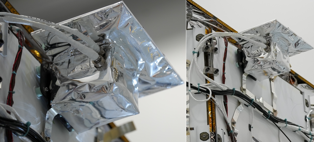 Left: a closeup of a metallic cube topped by a metallic platform mounted to a flat white structure. Wires protrude from the mounted cube. Right: the same metallic cube and platform shown from a further viewpoint; the white structure they are mounted upon is covered with numerous wires.
