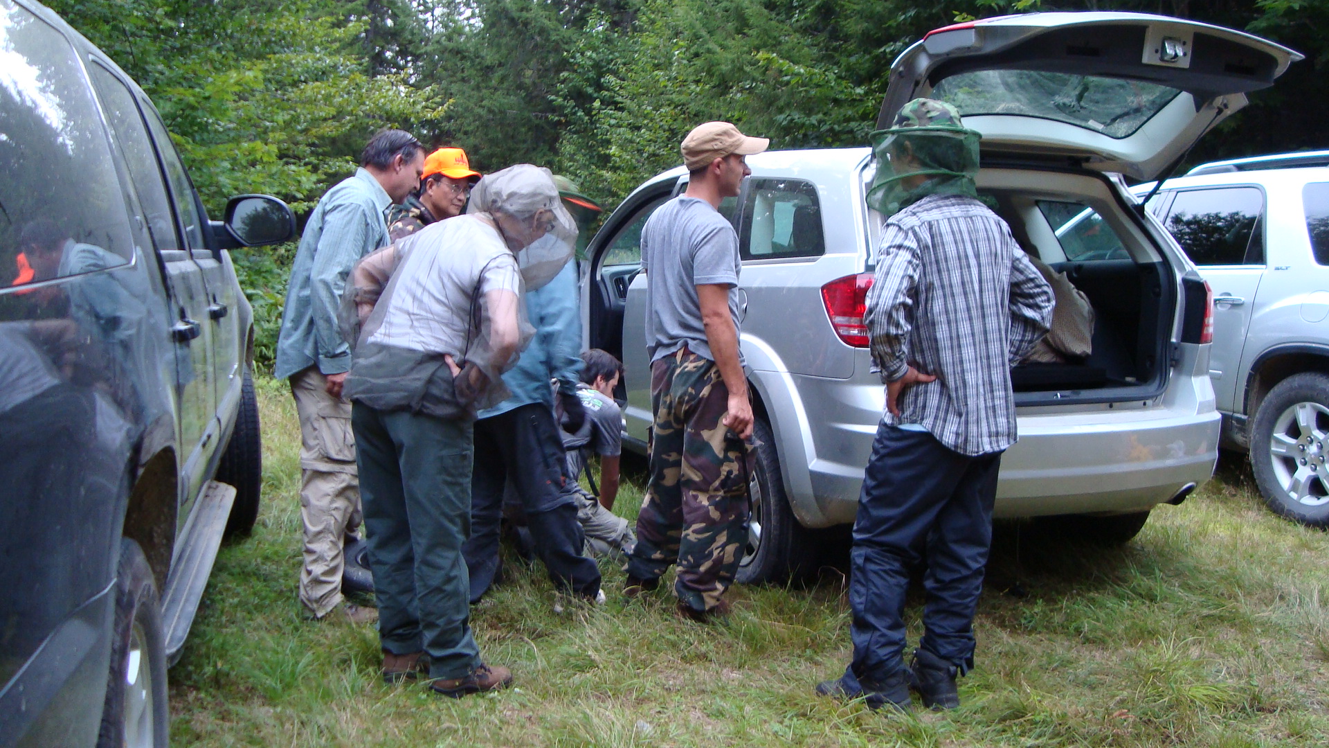 How many Ph.D.s does it take to change a tire? Paul Montesano and Jeremy Rubio doing the hard work, while other scientists help via careful observation. 