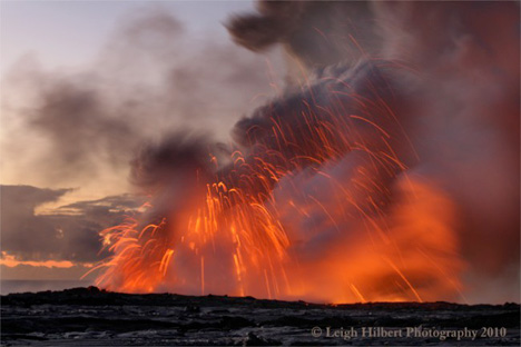 Incandescent rocks fly through the air during a lava bench collapse along the Hawaiian coast.