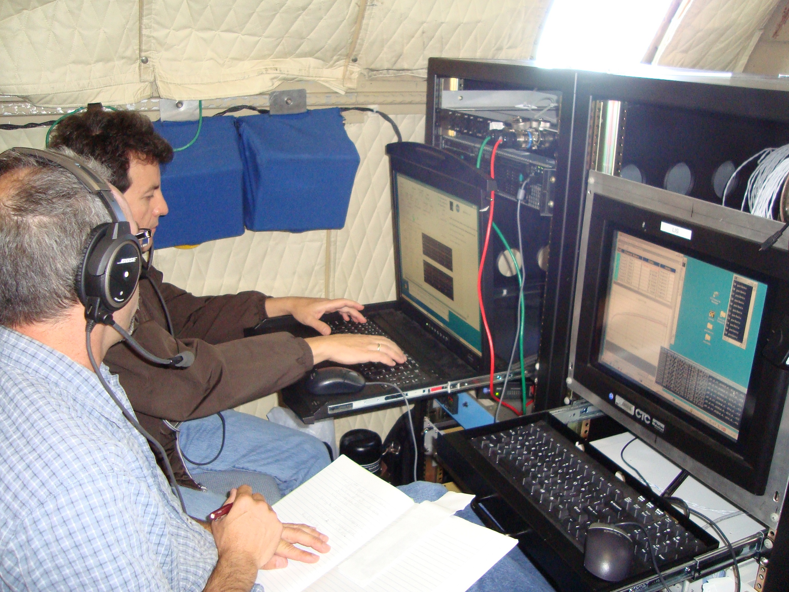 Rafael Rincon and Martin Perrine hard at work testing the DBSAR RAID, which had an intermittent problem collecting data rapidly, but only in flight. The repair efforts were successful.