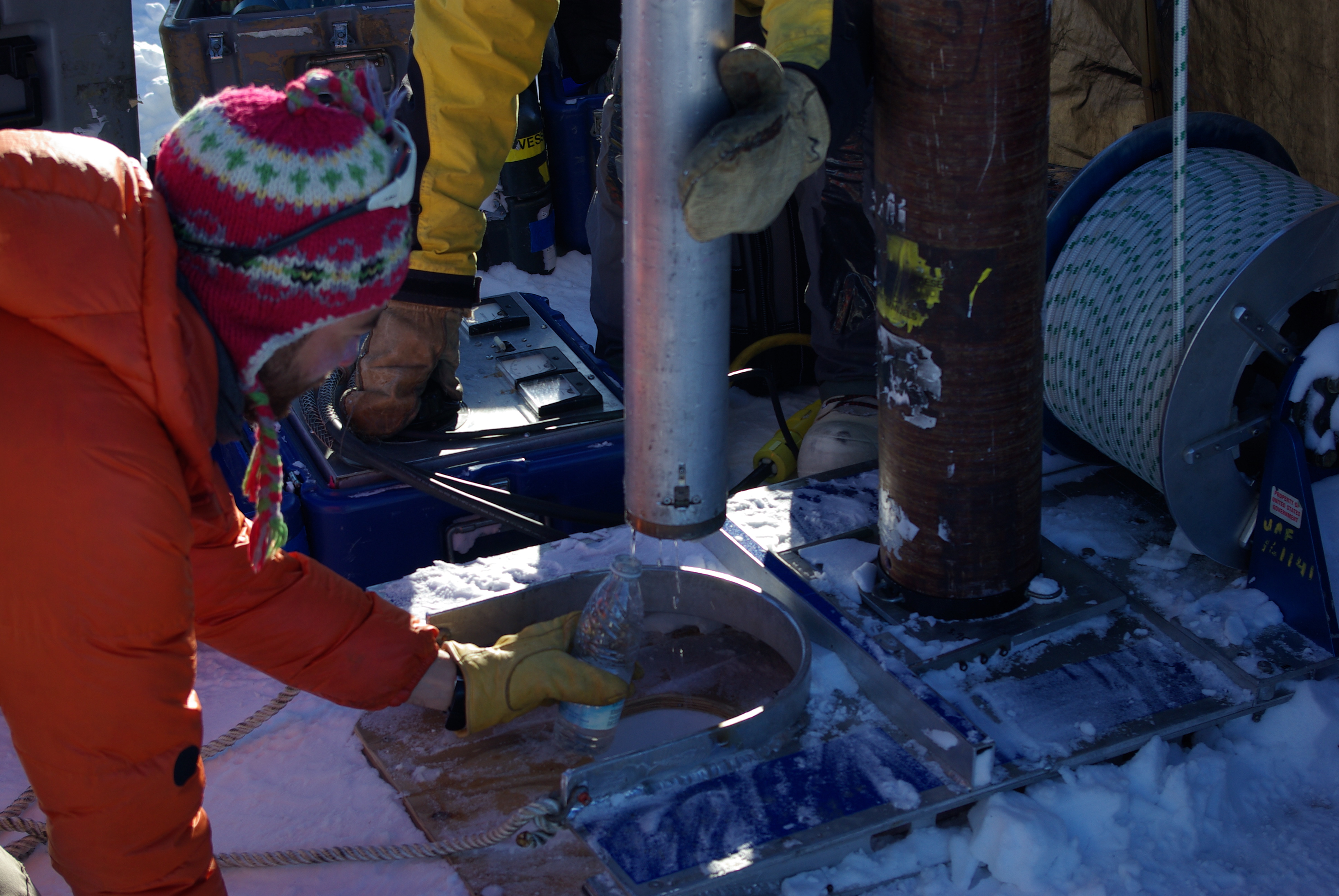 Clem collects some of the water dripping from the drill.