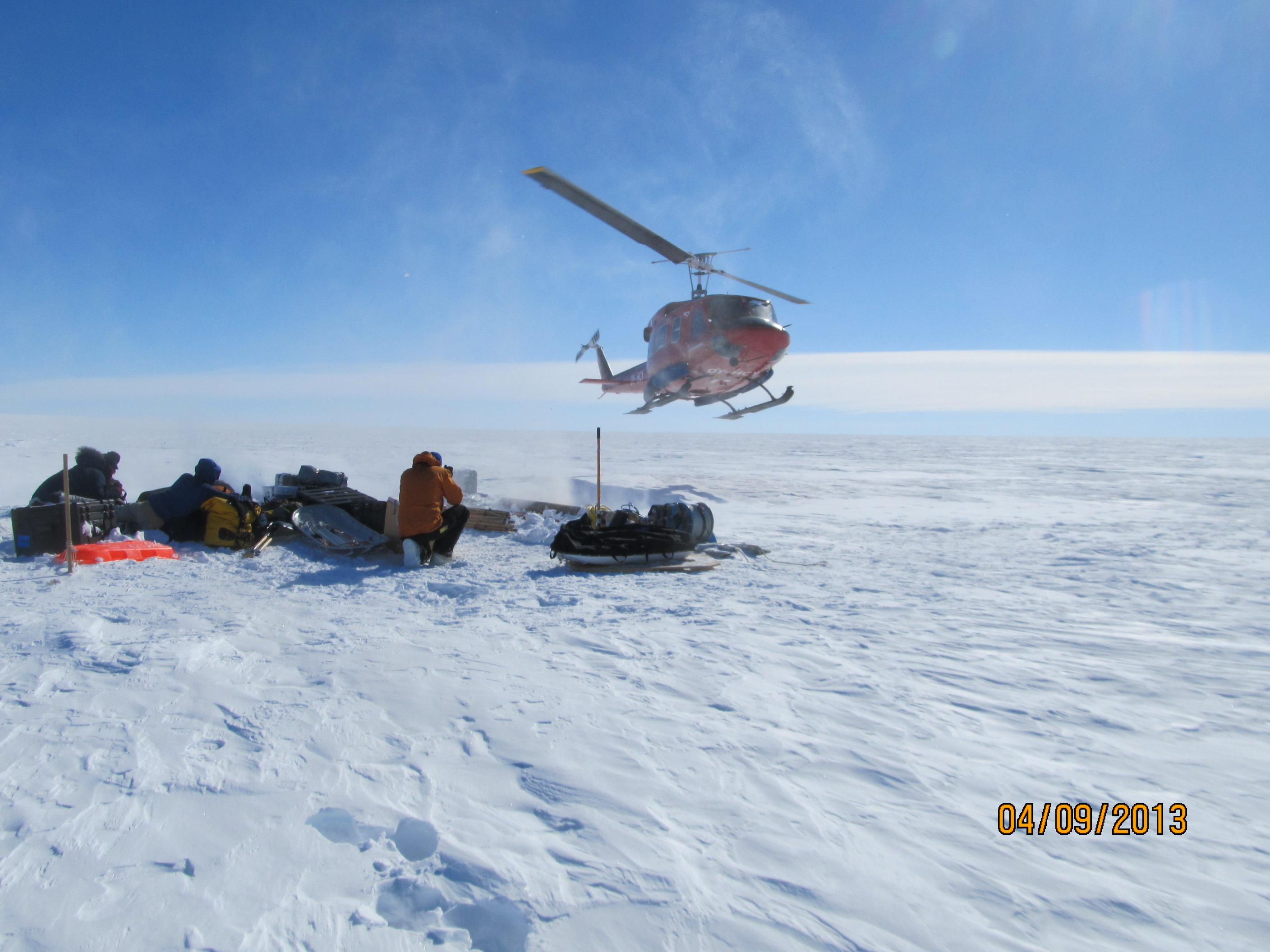 Helicopter landing to pick up cargo.