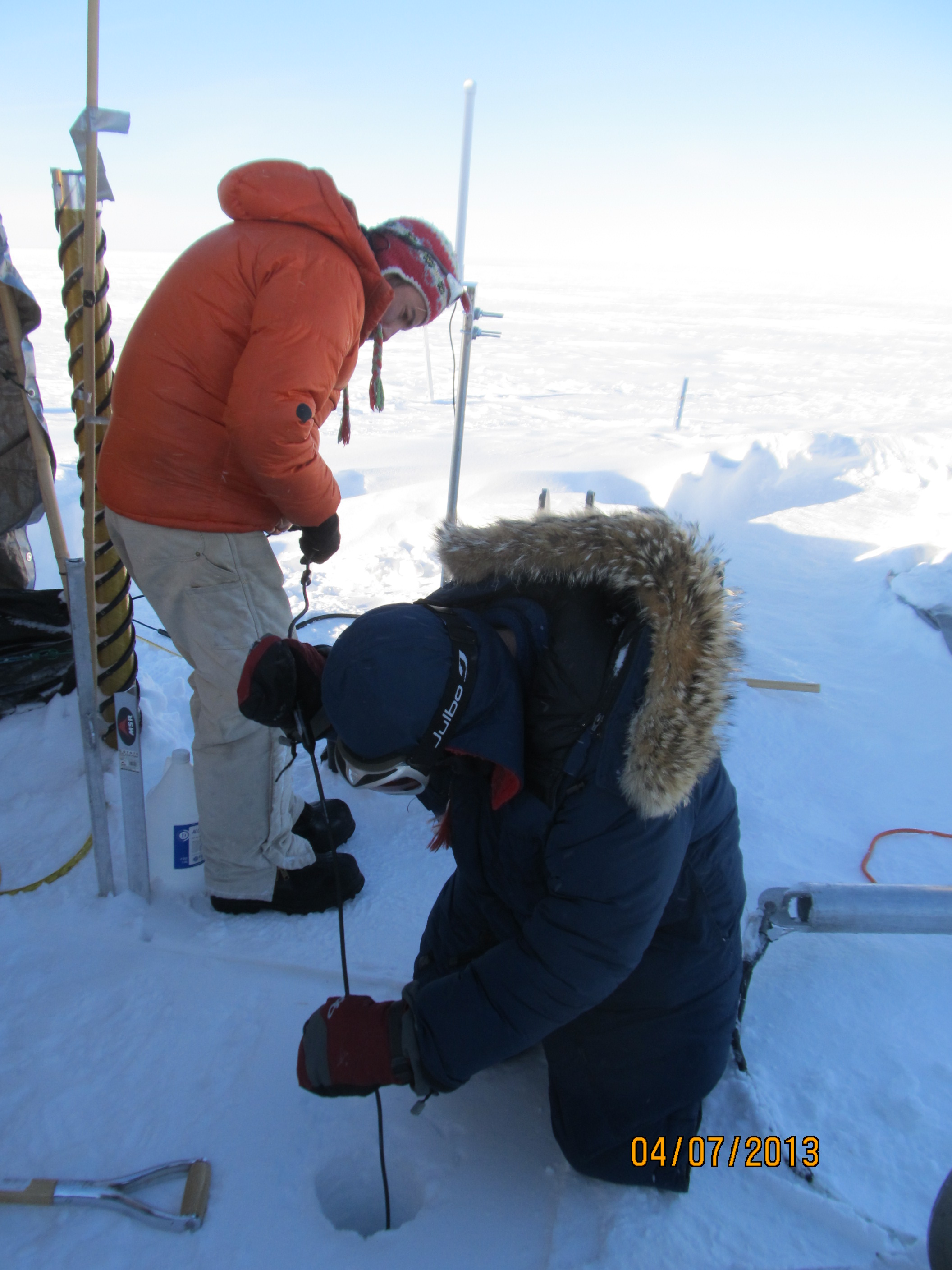 Lowering the second thermistor string down the 30-meter hole.