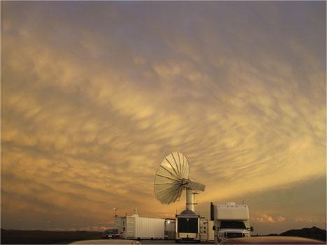 The NPOL radar against a bacground of wavy clouds at sunset.