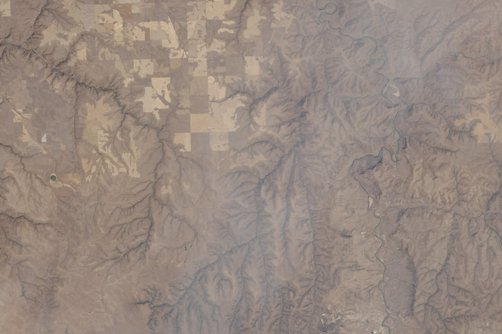 Detail showing scrub, fallow fields, and smoke.