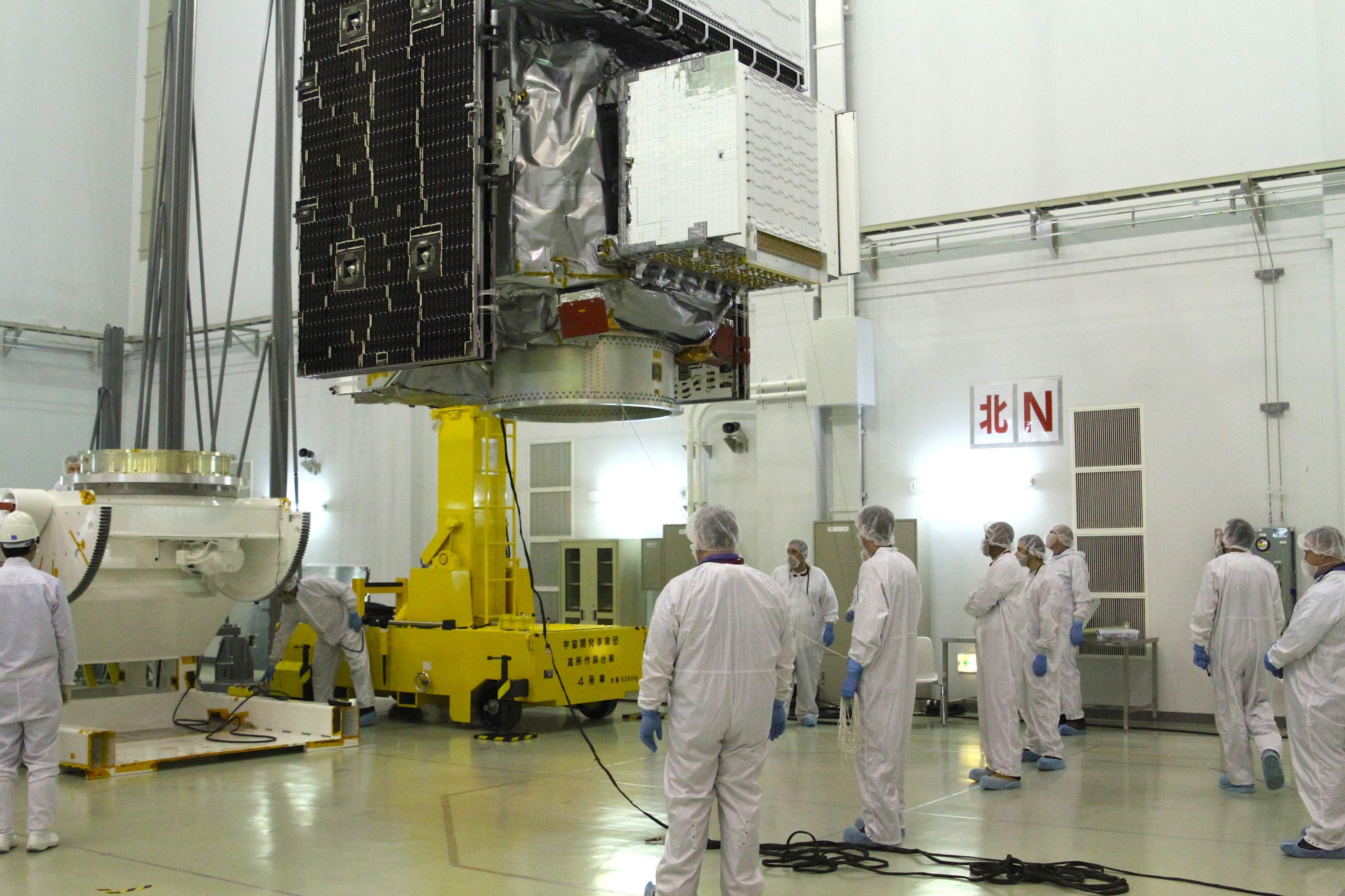 The GPM satellite is moved by crane across the clean room to the Aronson table which will support the satellite while the GPM team does its final preparations and testing before launch. Credit: NASA / Micheal Starobin