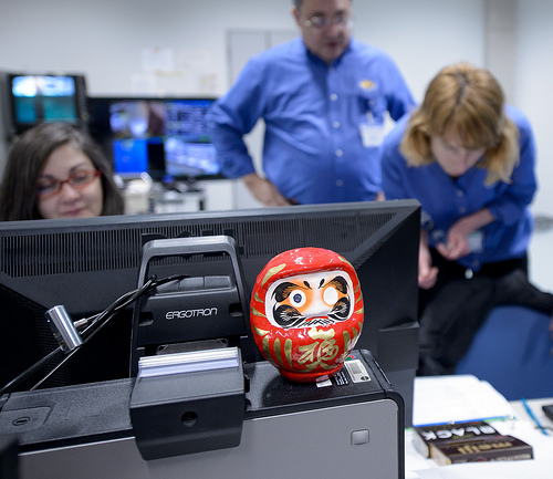 A daruma doll is seen amongst the NASA GPM Mission launch team in the Spacecraft Test and Assembly Building 2 (STA2) during the all-day launch simulation for the Global Precipitation Measurement (GPM) Core Observatory, Saturday, Feb. 22, 2014, Tanegashima Space Center (TNSC), Tanegashima Island, Japan. One eye of the daruma doll is colored in when a goal is set, in this case a successful launch of GPM, and the second eye is colored in at the completion of the goal. Credit: NASA/Bill Ingalls