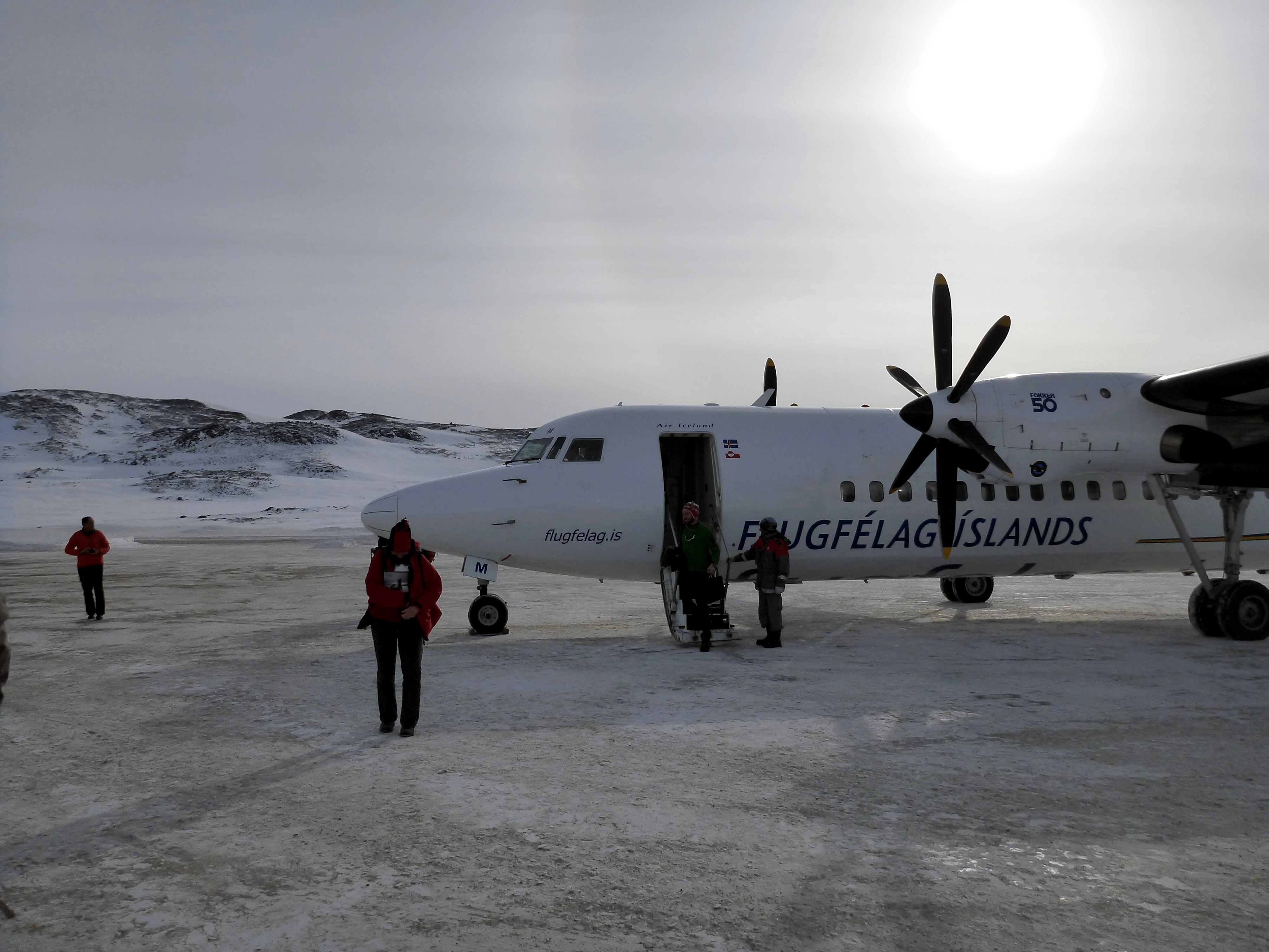 Our plane, freshly landed at the Kulusuk airport, with a faint sun halo in the background. (Credit: Rick Foster)