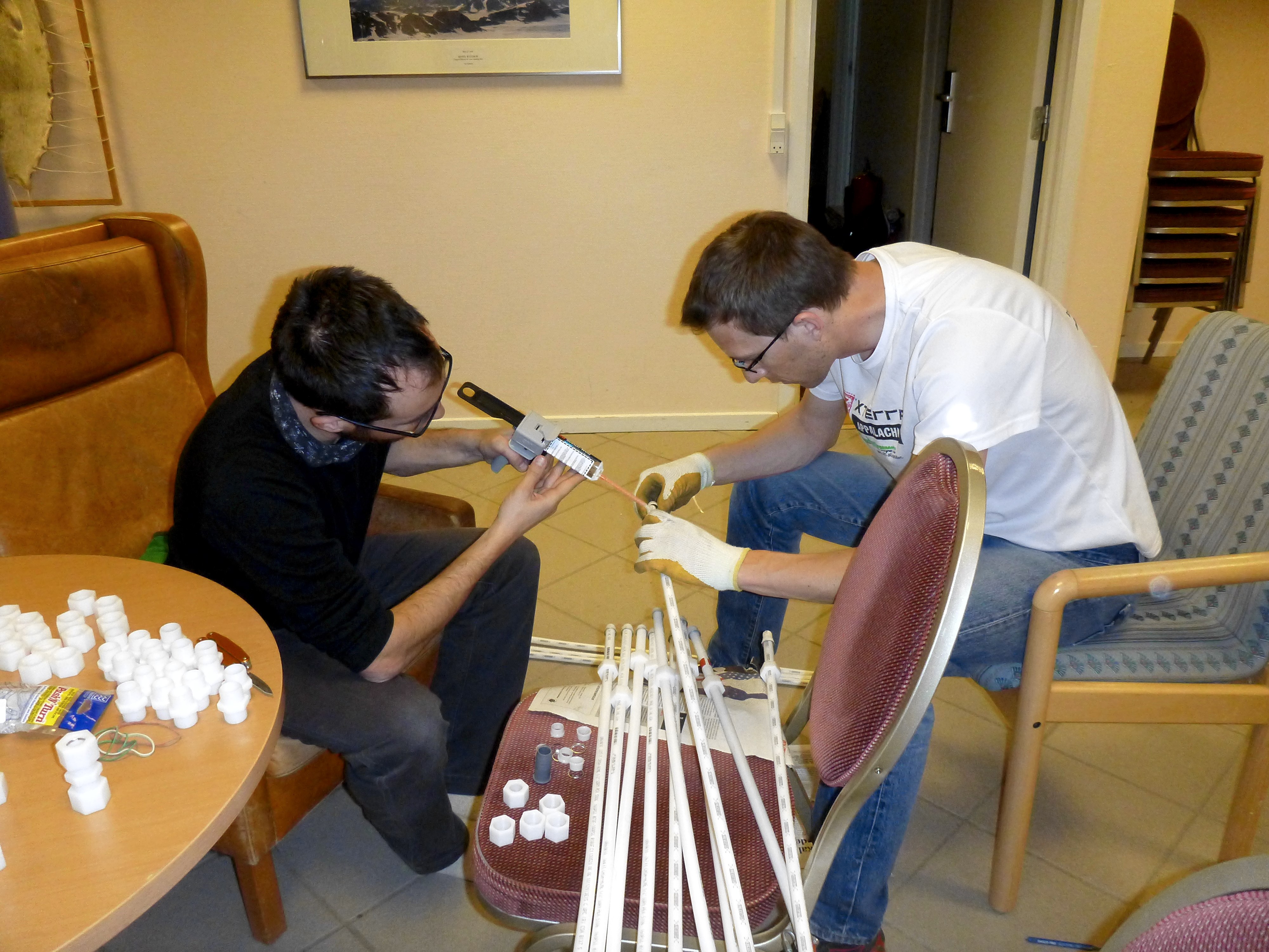 Ludo and Clem, working on gluing the coupling made to connect the radar antenna tubes. (Credit: Rick Foster.)