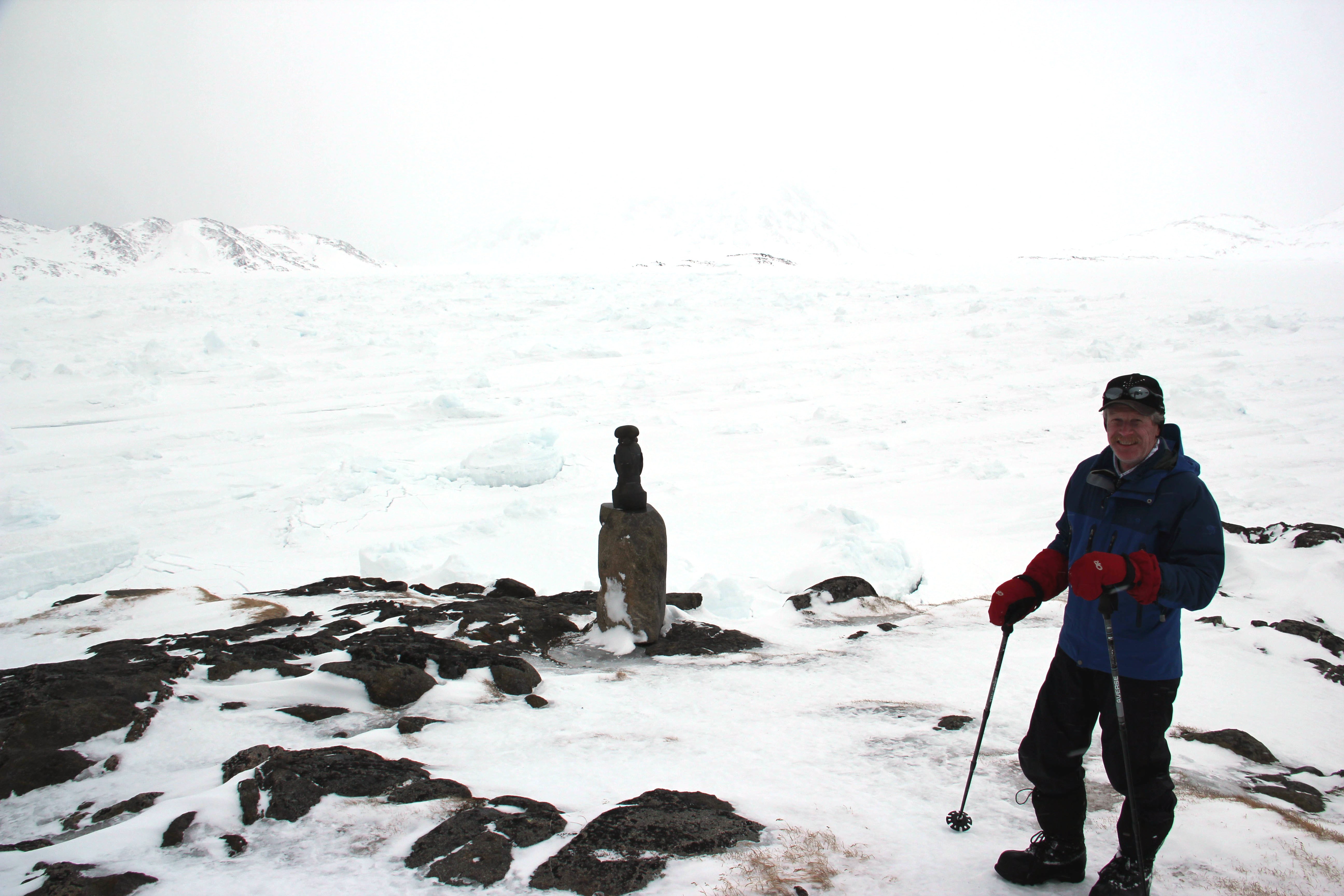 Rick in front of the broken and refrozen sea ice. Imagine how different it is from the open ocean in the summer, with boats cruising around.  (Credit: Clément Miège.)