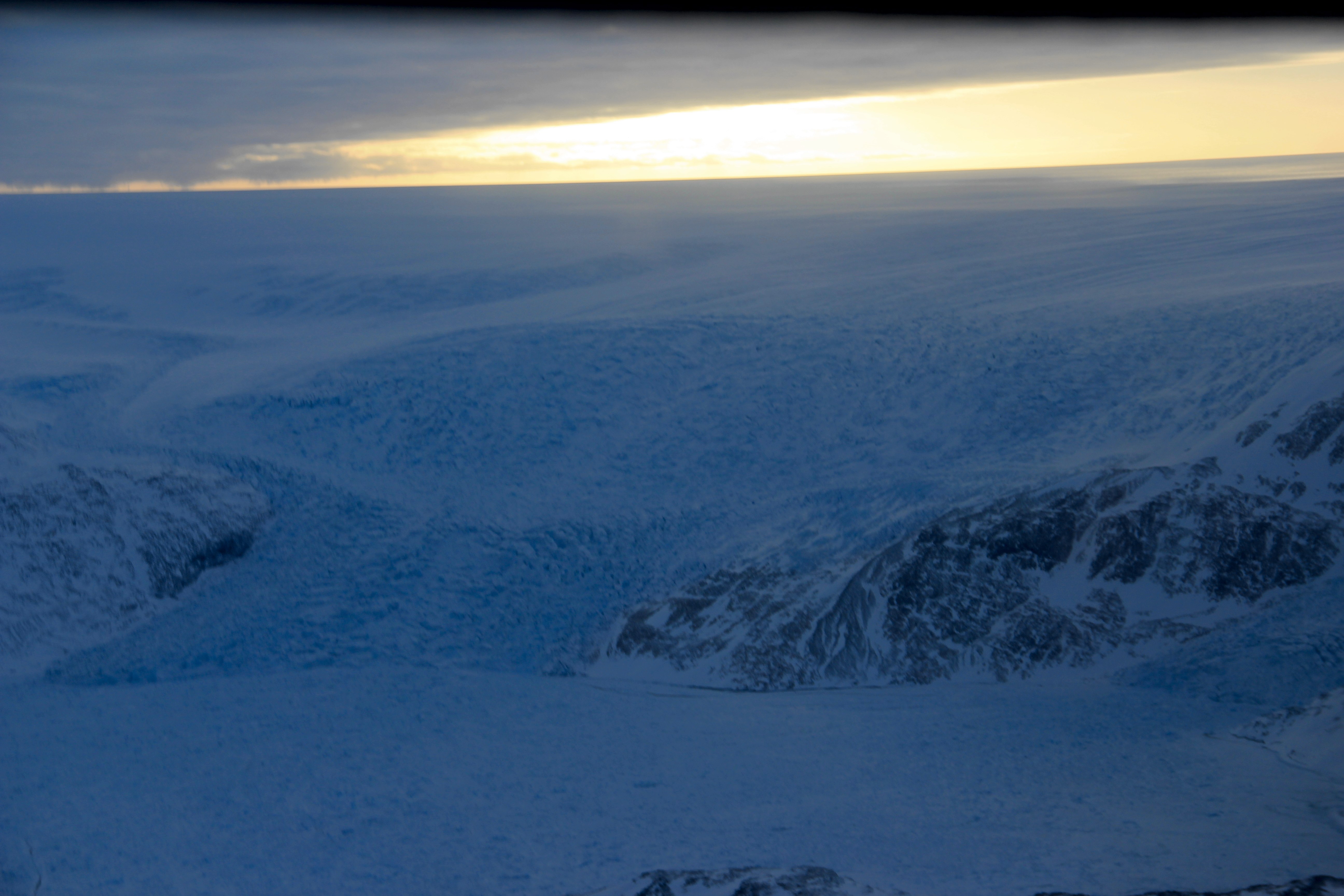 Approaching the ice sheet's edge with the B-212 helicopter. (Credit: Clement Miège.)