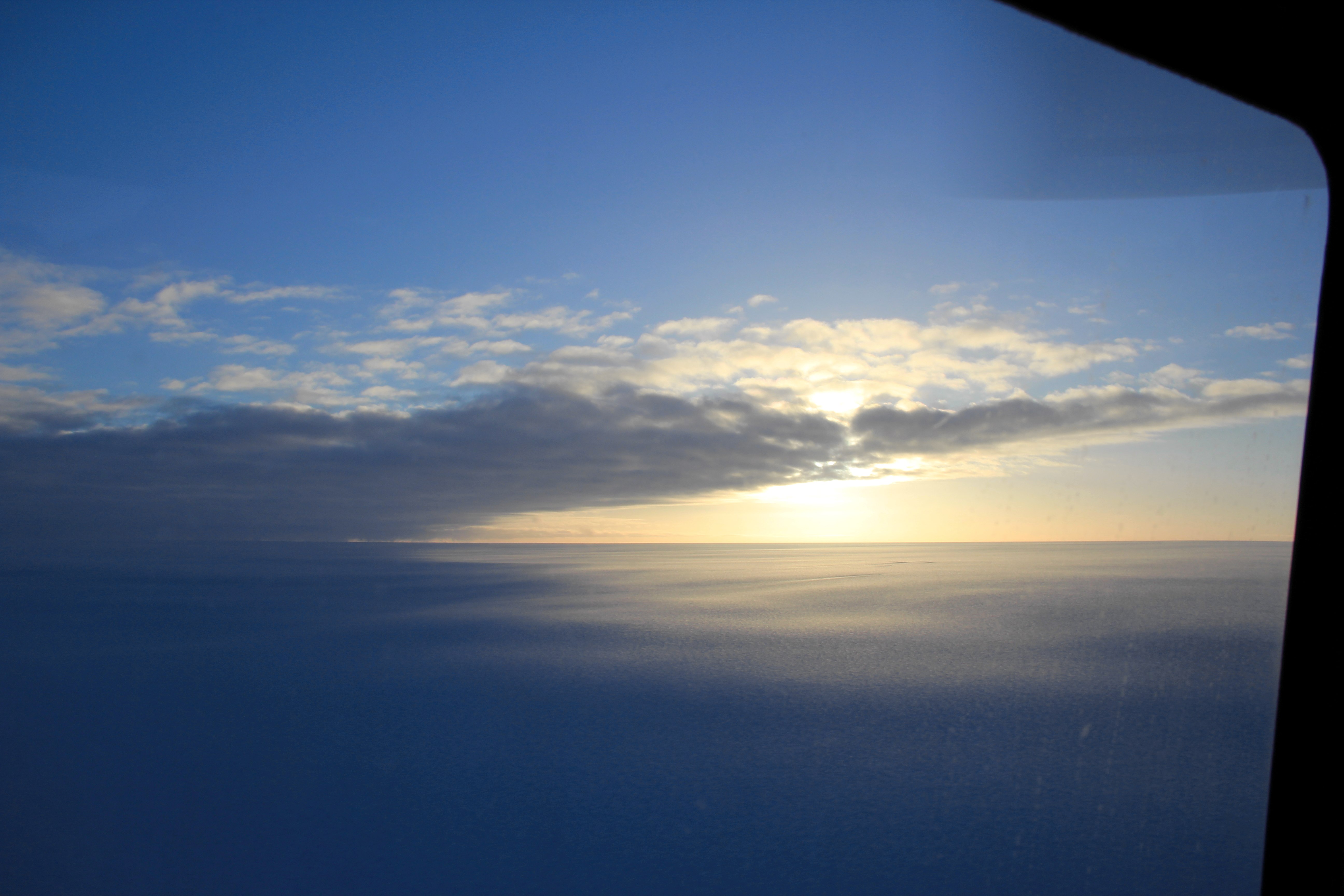 Approaching the ice sheet's edge with the B-212 helicopter. (Credit: Clement Miège.)