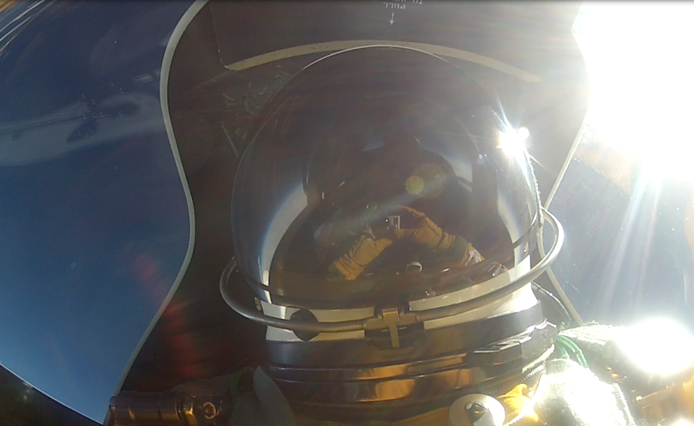 Denis Steele sets up a video camera in the cockpit of the ER-2, 65,000 feet over Alaska's southern mountains.