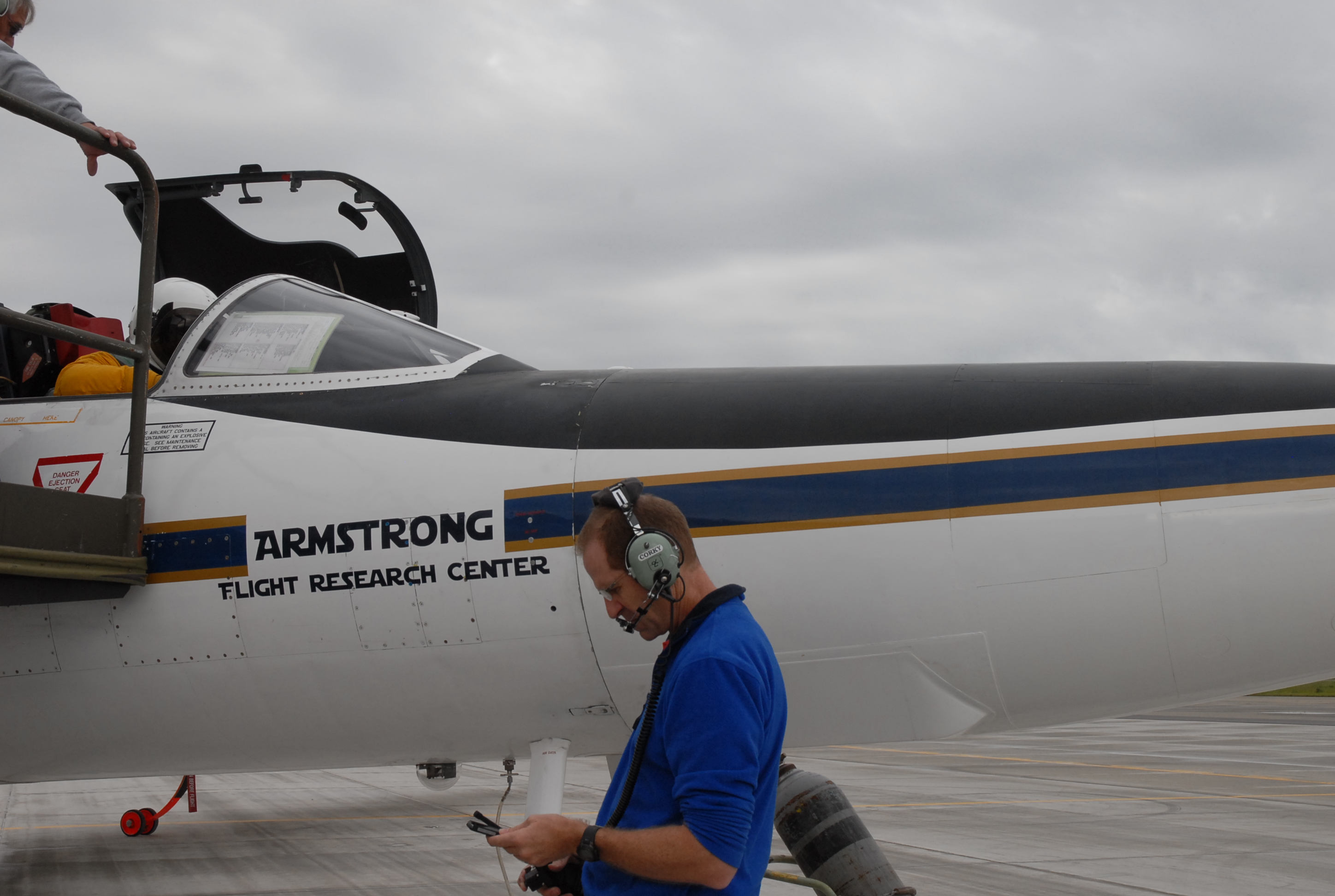 ER-2s Denis Steele, in the cockpit, and Tim Williams, checking notes, get ready for the day's flight. (Credit: Kate Ramsayer/NASA)