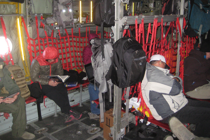 Lora reading on a cold flight over to Greenland.