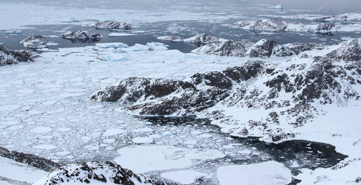 Views on the sea ice, ocean and a few icebergs.
