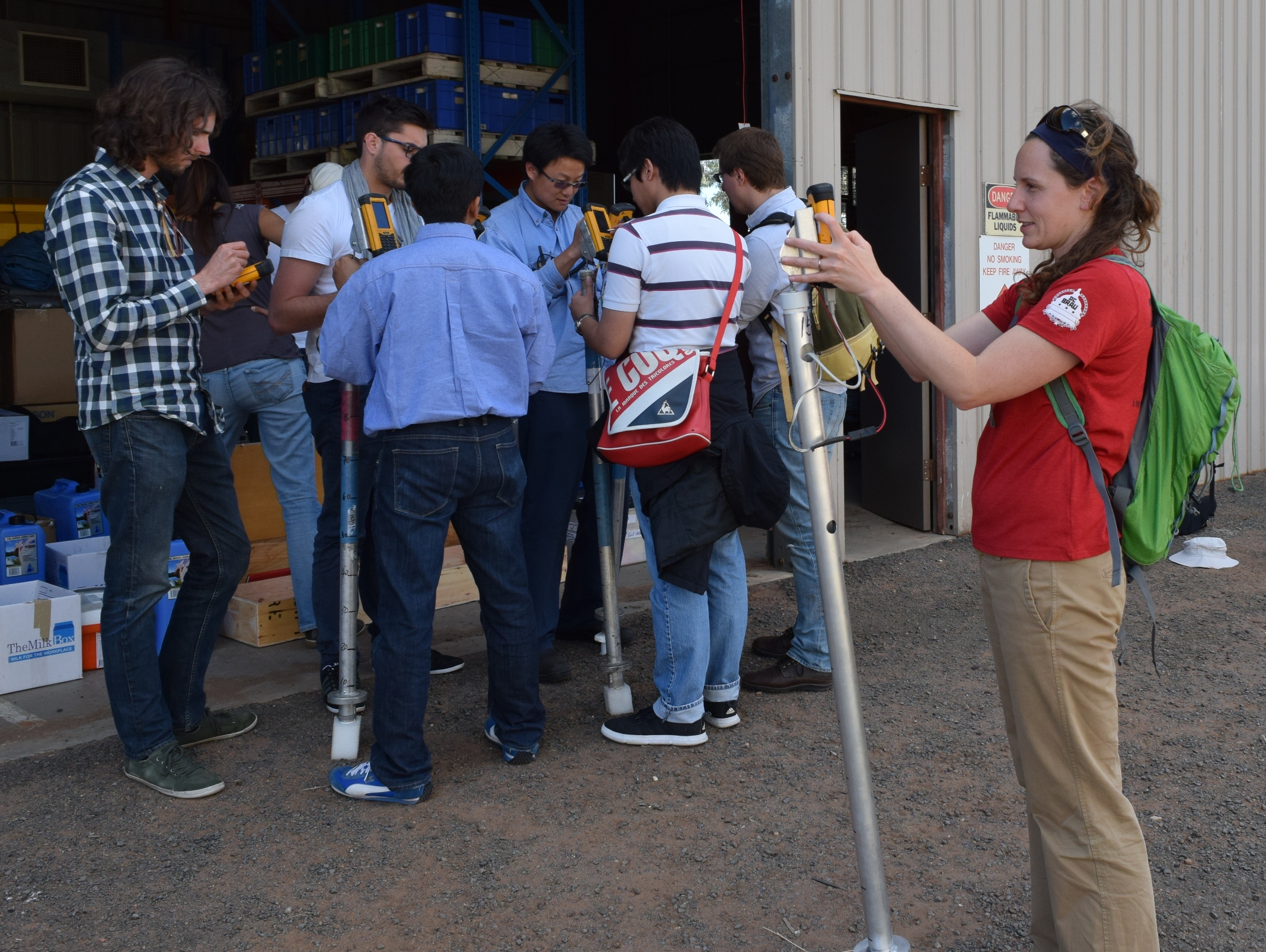 Amy NcNally (Front) of NASA, Alex White (Far left) of USDA and other members learn how to operate their field equipment.