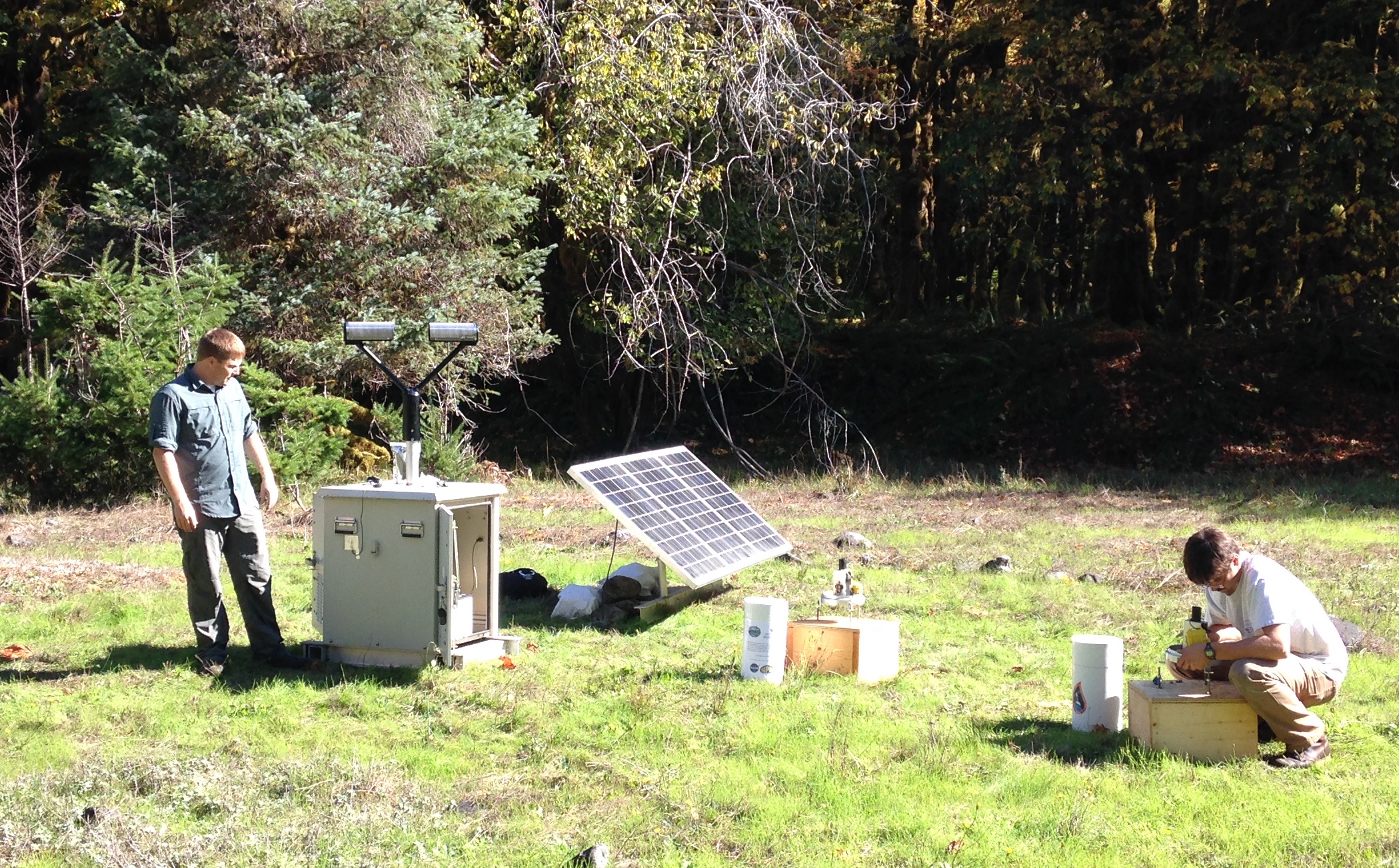 Matt Wingo (NASA) and CJ Urnes (Olympic National Park) install rain gauges and a Parsivel disdrometer (an instrument that measures sizes of falling precipitation) in the Olympic Mountains. (Photo by Joe Zagrodnik) 