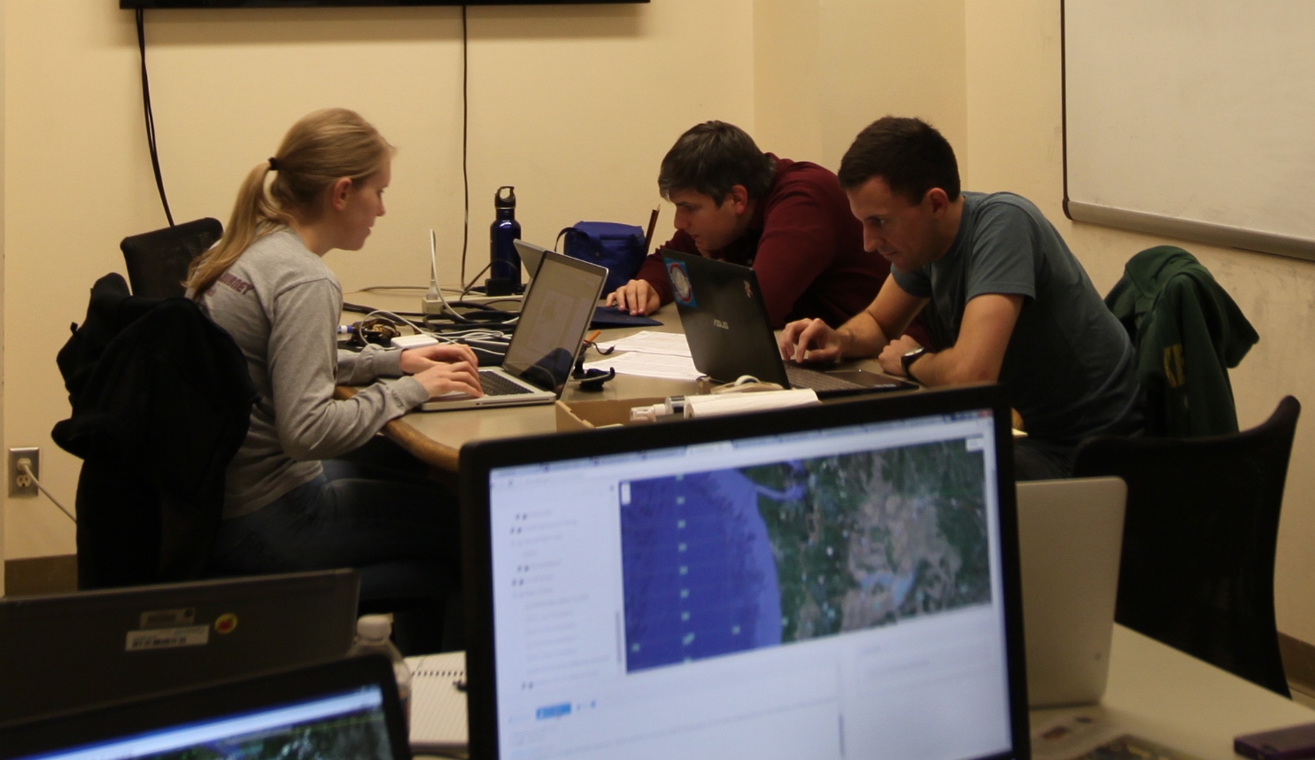 Forecasters getting ready for the morning briefing, Jen Dehart (left), Luke Madaus and Nick Weber (right).