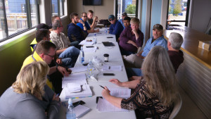 A group of people in discussion at a table.