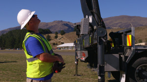 Technician looking up at a crane.