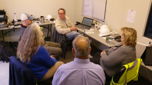 Balloon team sits in a room discussing flight plans.