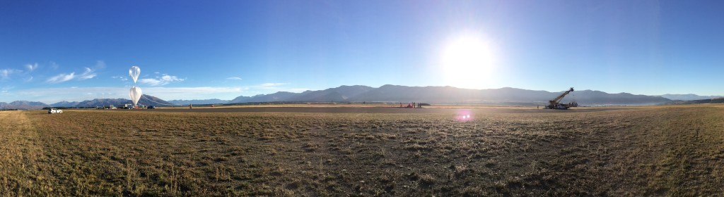 Panorama view of a balloon being prepared to launch with the payload at the end.