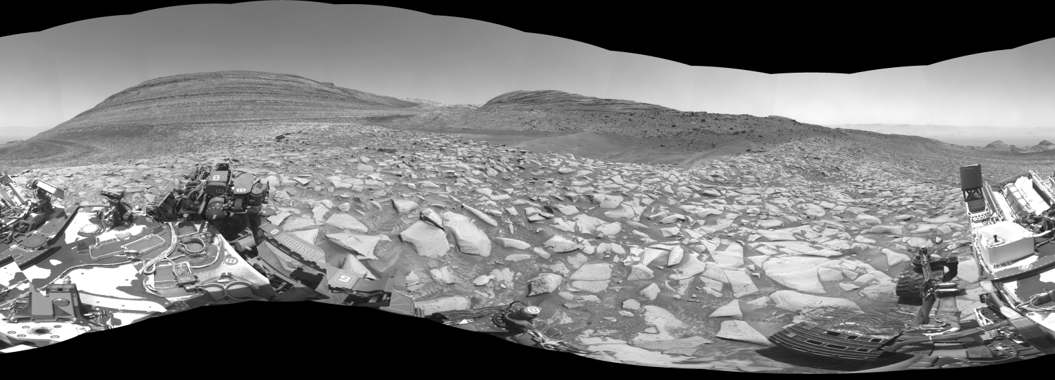 Black-and-white panoramic landscape of Mars' rocky terrain