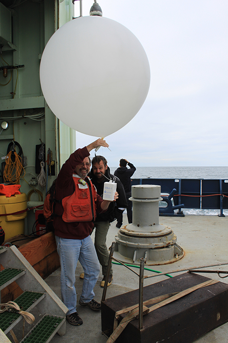 A weather balloon is filled with helium and the radiosonde is attached. Photo: Jim Johnson
